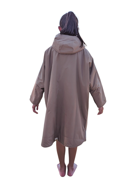Child wearing a brown hooded changing robe on a white background