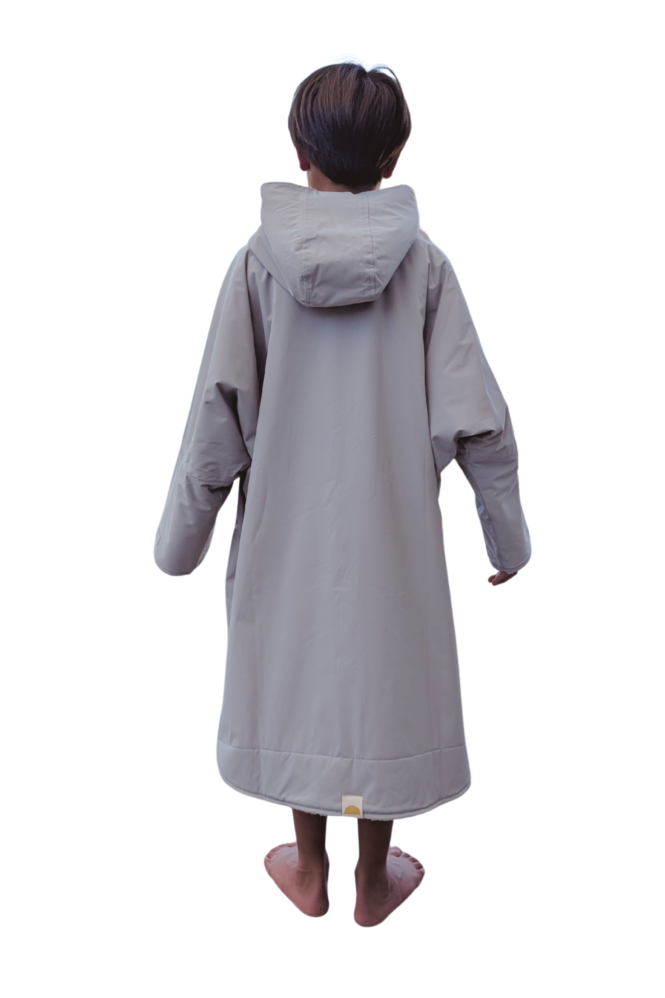 Child wearing a long grey changing robe on a white background
