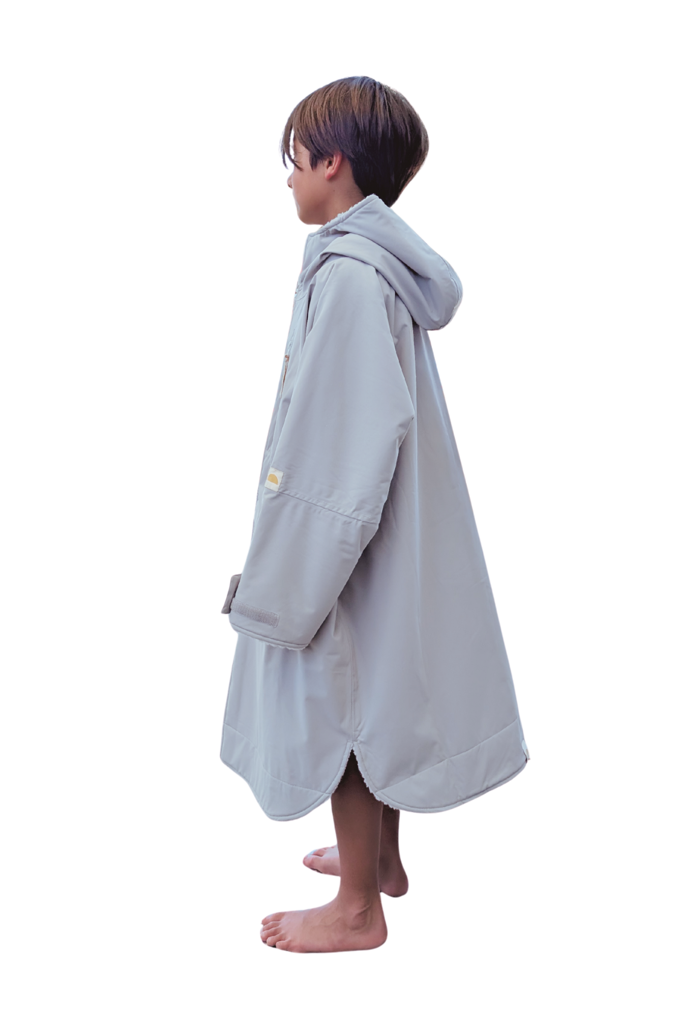 Child wearing a gray hooded changing robe on a white background